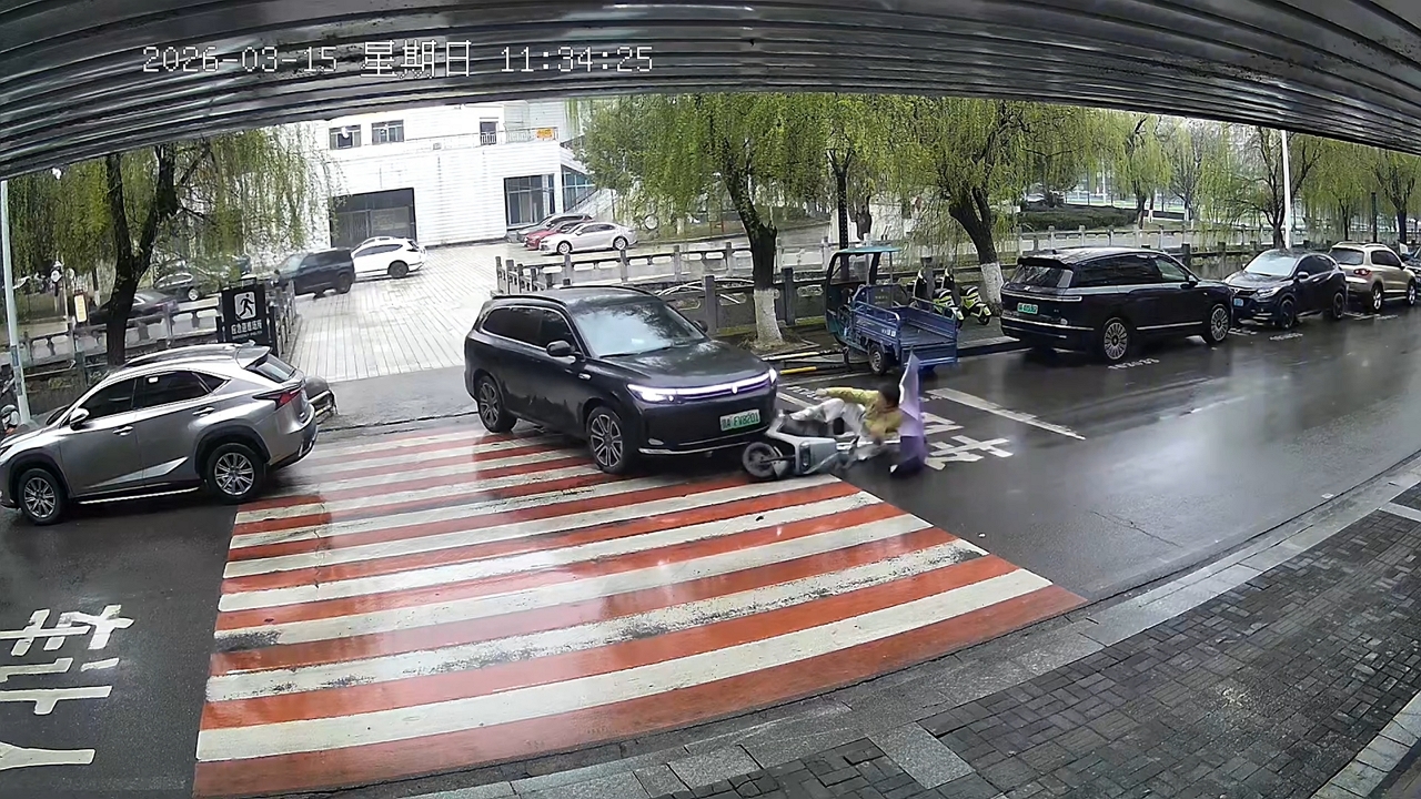 Video thumbnail for Scooter Slides Toward SUV on Rainy Road in China