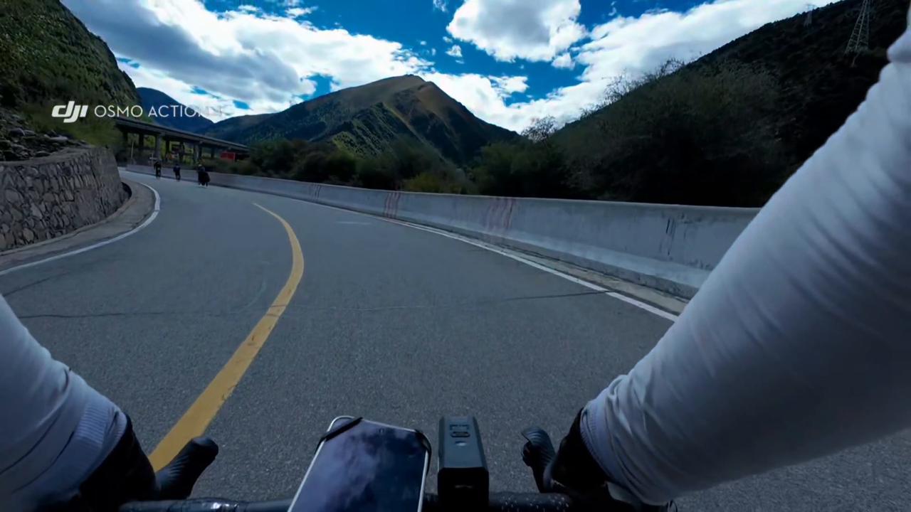 Video thumbnail for China: Cow in China chases tired cyclists up steep road.