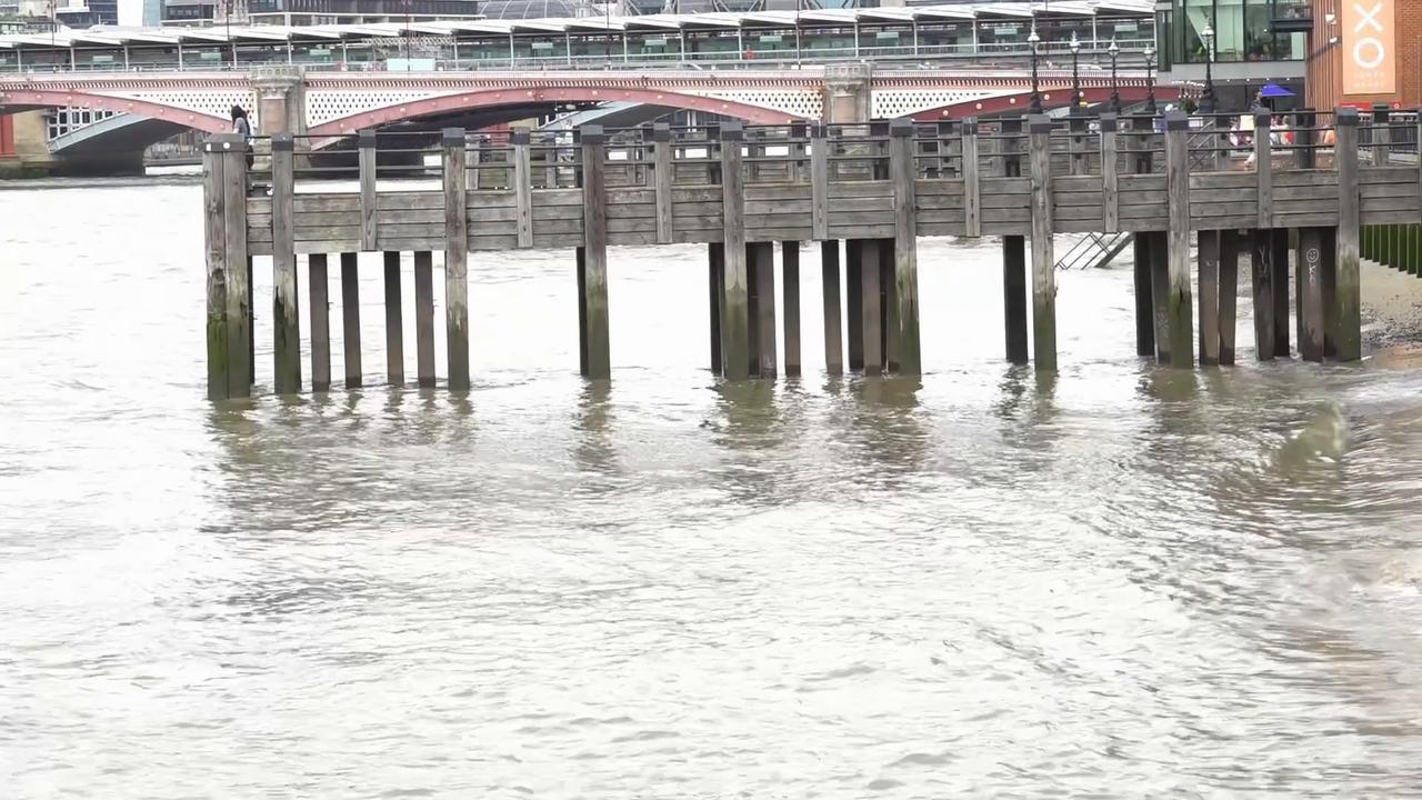 Video thumbnail for UK: River Thames turns murky near Tower Bridge following rainfall in London (2).