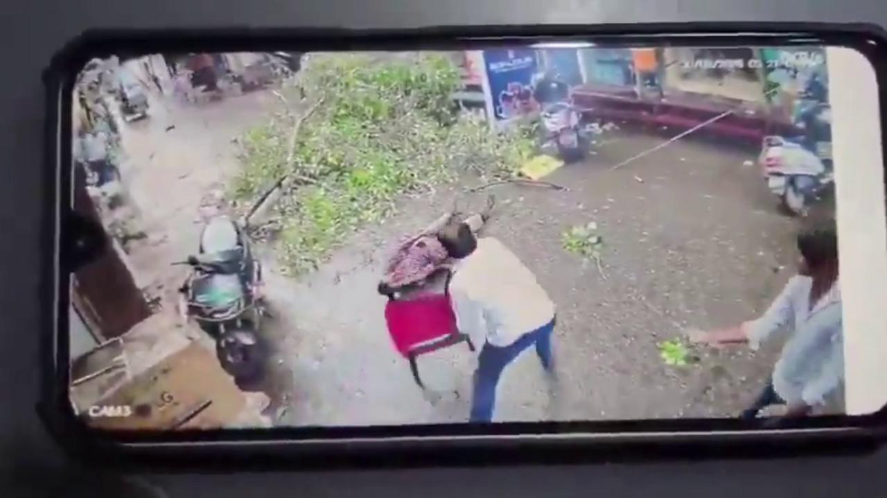 Video thumbnail for India: Tree branch crashes onto power lines in main market, broken wires fall on road, seriously injure elderly man.