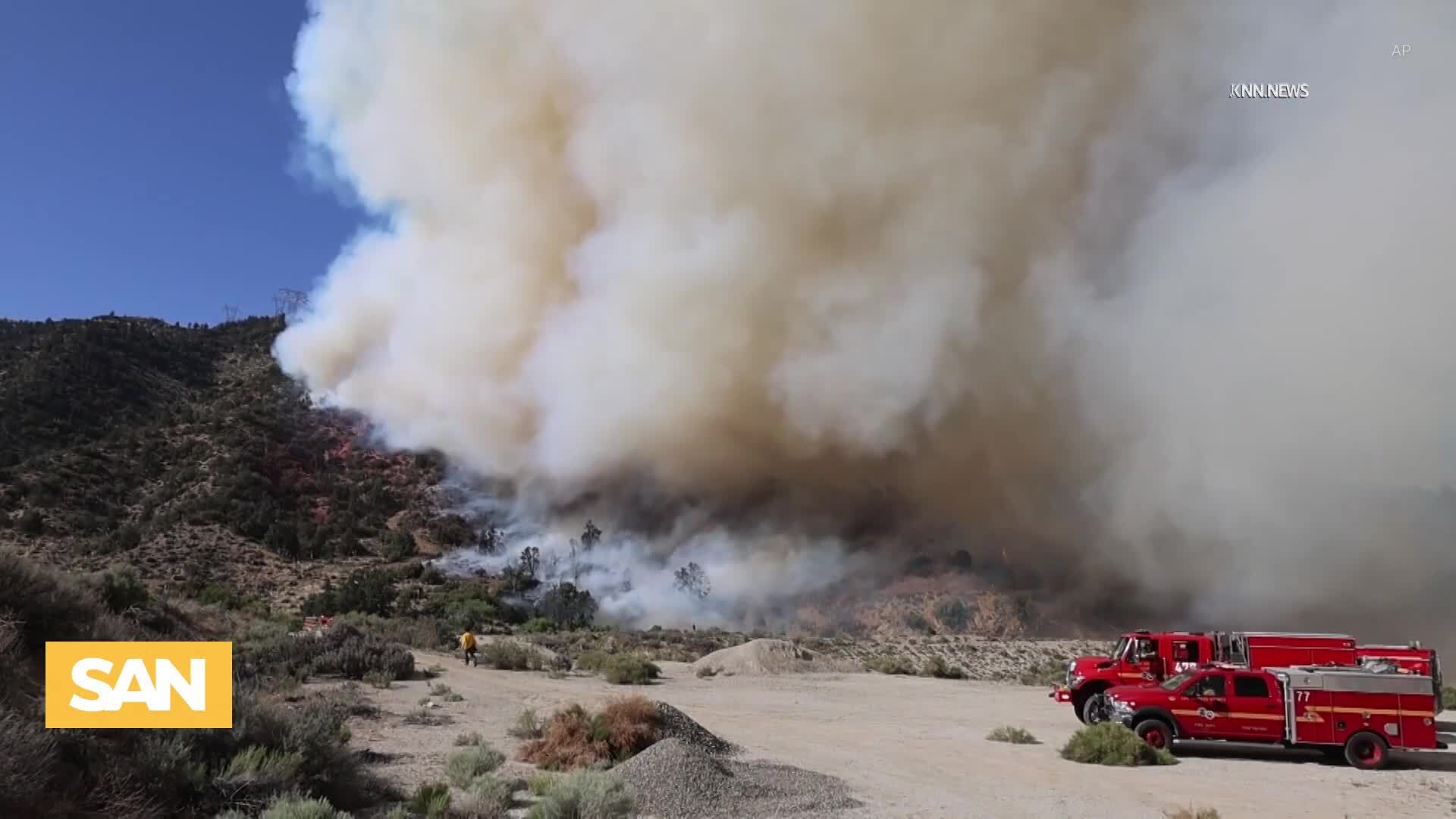 Video thumbnail for Thousands evacuated as wildfires rage across Canada, US sends firefighters