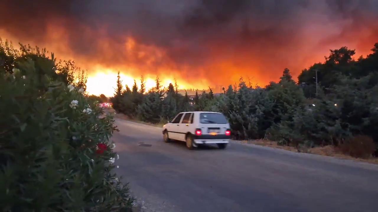 Video thumbnail for Turkey: Wind-Driven Wildfire Threatens Homes, Prompts Evacuations in Fethiye.