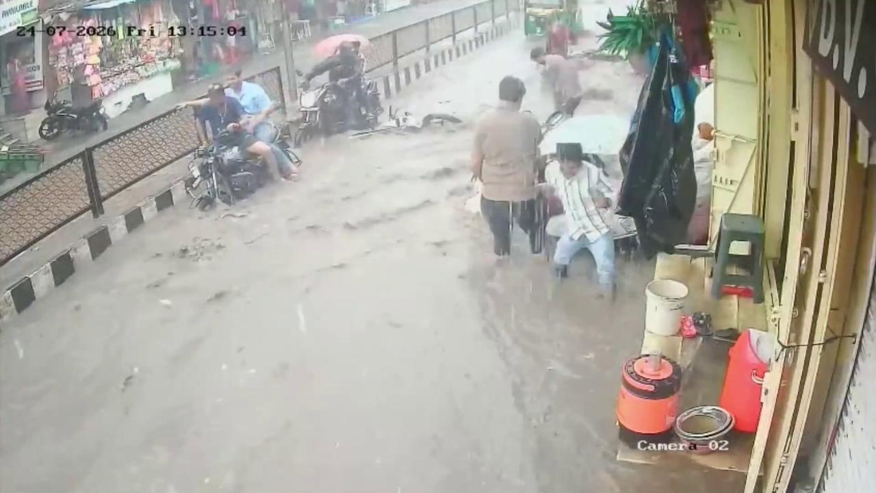 Video thumbnail for India: Relentless rain turns busy market into raging water channel while powerful currents sweep parked motorcycles.