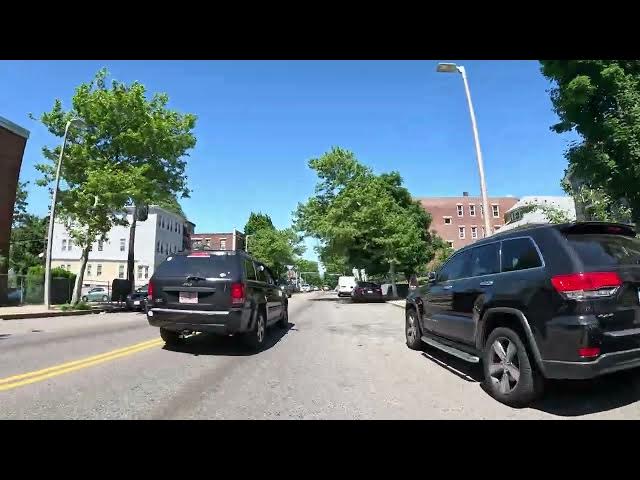 'Video thumbnail for Biking a Large Hill in Roslindale, a Boston Neighborhood, With a View of Skyline and Local Village'