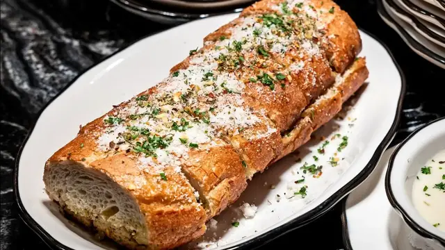 'Video thumbnail for The Sneaky Reasons Why Restaurant Garlic Bread Tastes So Good'
