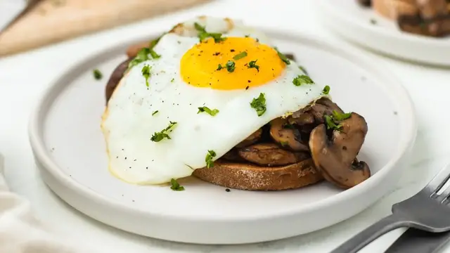 'Video thumbnail for Garlicky Mushroom Toast With Fried Egg Recipe'