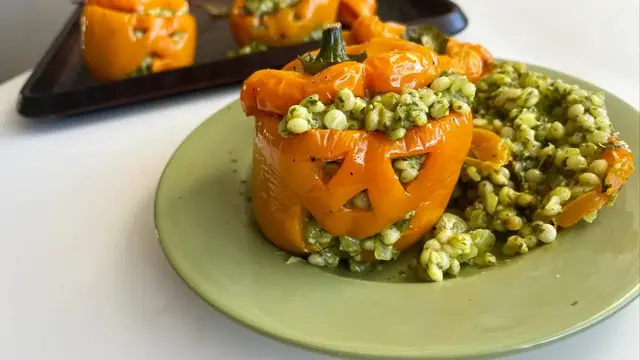 'Video thumbnail for Jack-O-Lantern Couscous-Stuffed Peppers Recipe'