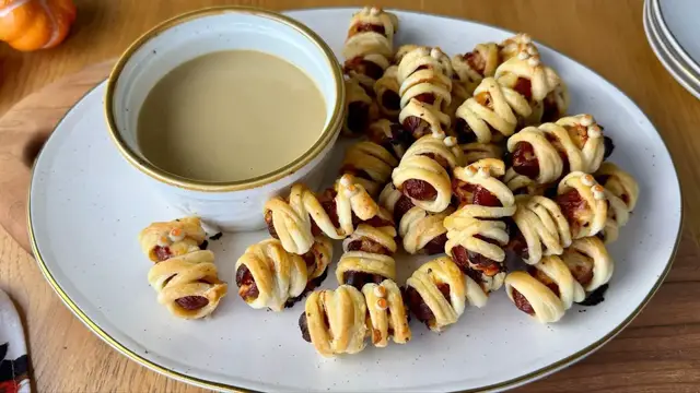 'Video thumbnail for Miniature Cheesy Hot Dog Mummies With Dijon Dipping Sauce Recipe'