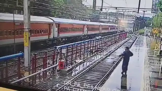 Video thumbnail for India: Elderly man falls from moving train, brave official rushes onto tracks for daring rescue.