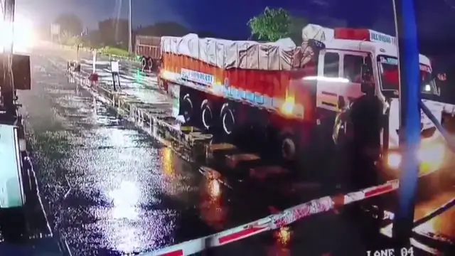 Video thumbnail for India: Speeding truck slams into toll booth, massive fire engulfs vehicles, one fatality reported.