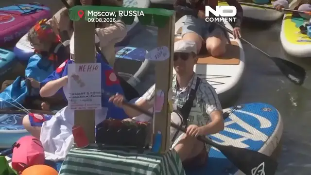 Video thumbnail for Costumed paddleboarders float down Moscow river in carnival