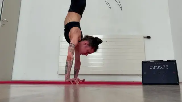 Video thumbnail for Most Consecutive Nose To Ground Handstand Push Ups (Female)