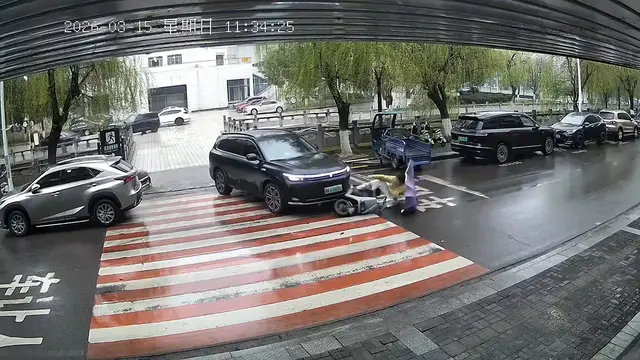 Video thumbnail for Scooter Slides Toward SUV on Rainy Road in China