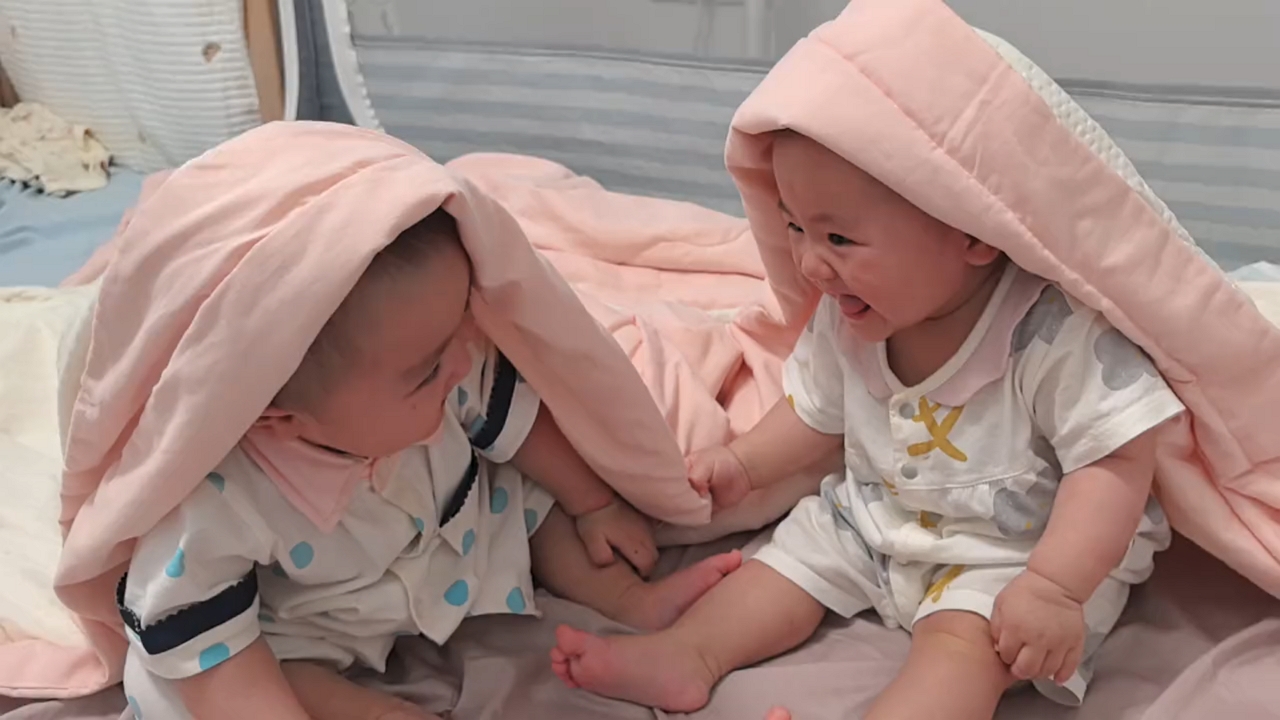 Video thumbnail for Twin Babies Burst into Giggles Under Blanket