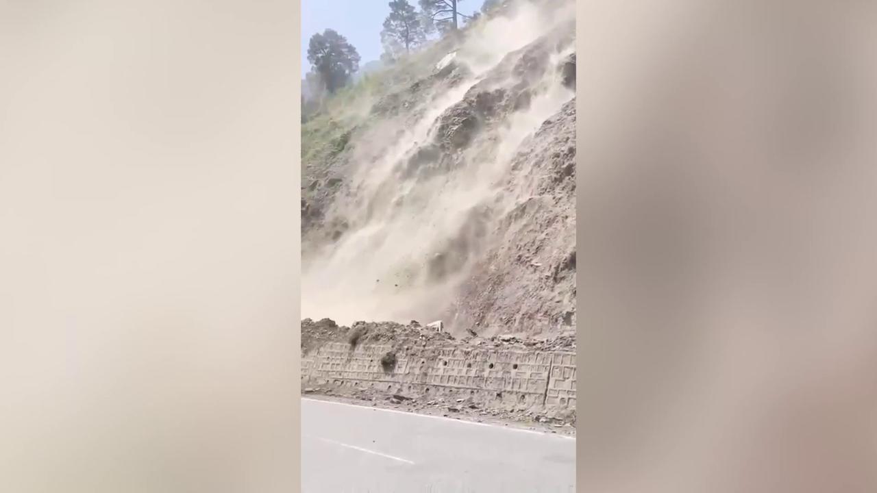 Video thumbnail for Intermittent shooting stones disrupt highway, rocks roll down from hillside creating danger.