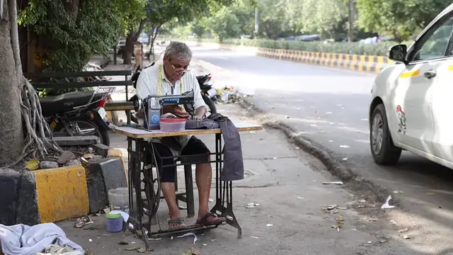 Video thumbnail for India: Roadside tailor master working.