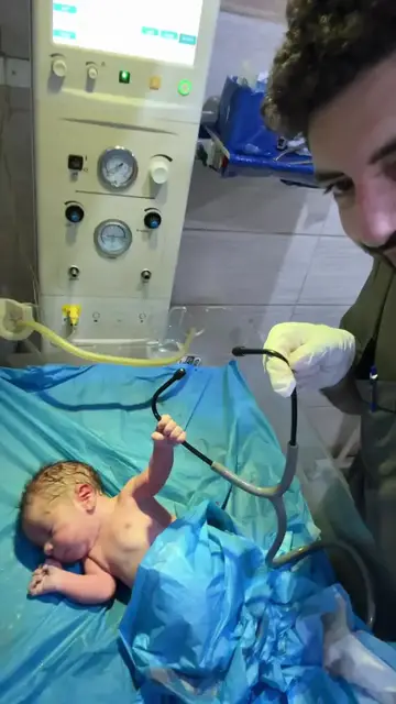 Video thumbnail for Newborn Baby Grasping a Stethoscope in Delivery Room