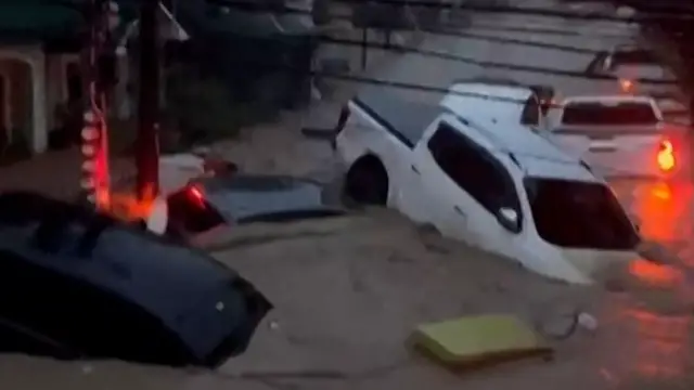 'Video thumbnail for Typhoon floods wash away containers and cars in Philippines'