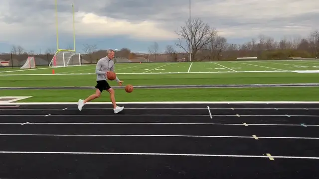 Video thumbnail for Fastest mile dribbling two basketballs