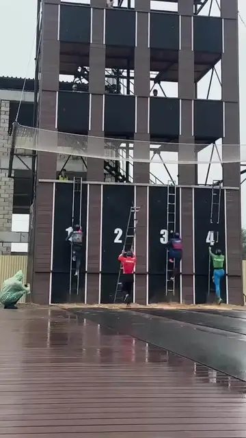 Video thumbnail for Rescue Athletes Sprint Up Tower Ladders in the Rain
