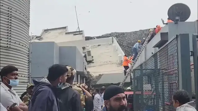 Video thumbnail for India: 16 feared trapped as waste mound crashes onto building in India's Maharashtra.