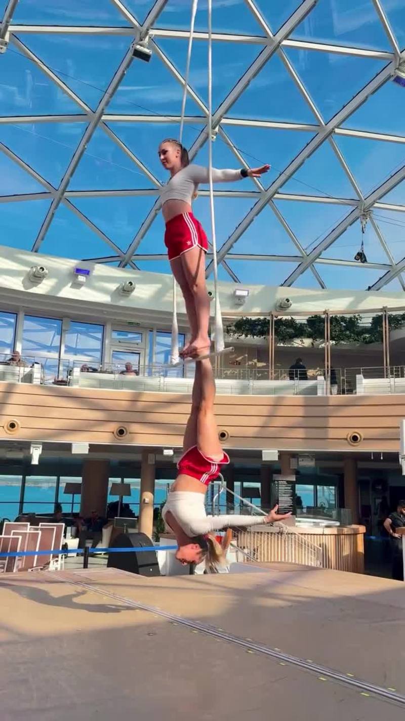 Video thumbnail for Dynamic Female Duo Performing Aerial Dance Trapeze at Sea
