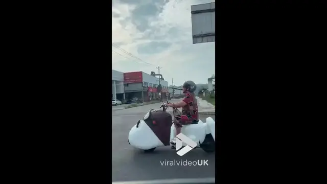 Video thumbnail for VV5048 Woman cruises the street on a dog scooter