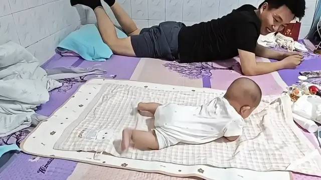 Video thumbnail for Baby Copies Dad Learning to Roll Over!