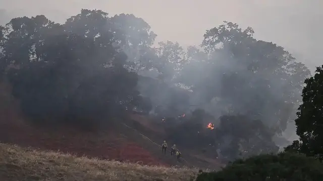 Video thumbnail for US: Firefighters battle 'Little Fire' in California as helicopters support ground operations.