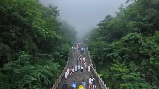 Video thumbnail for China: Clouds cross through Tianmen Cave, enchant visitors.