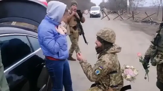 Video thumbnail for Ukrainian soldier proposes to woman at checkpoint during conflict