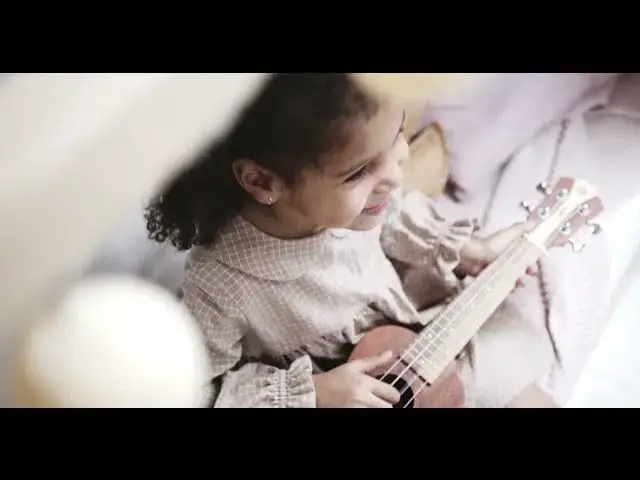Video thumbnail for Little girl playing a little guitar