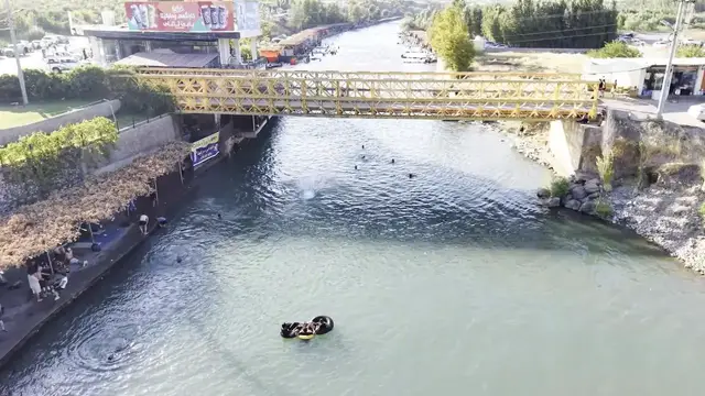 Video thumbnail for Iraq: DRONE - Iraqis take to Khabur River to escape scorching heat.