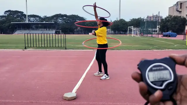Video thumbnail for Fastest 100m while spinning three hula hoops (female)  32.01 seconds by Janani .R.S