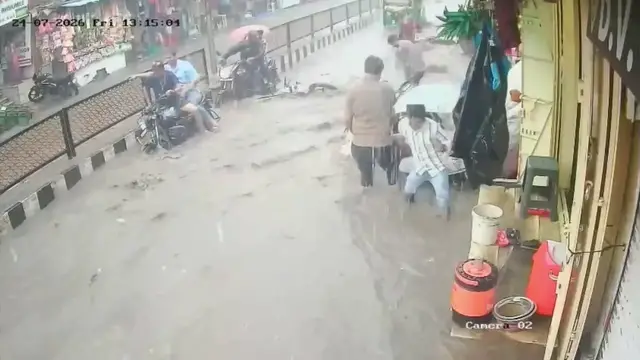 Video thumbnail for India: Relentless rain turns busy market into raging water channel while powerful currents sweep parked motorcycles.