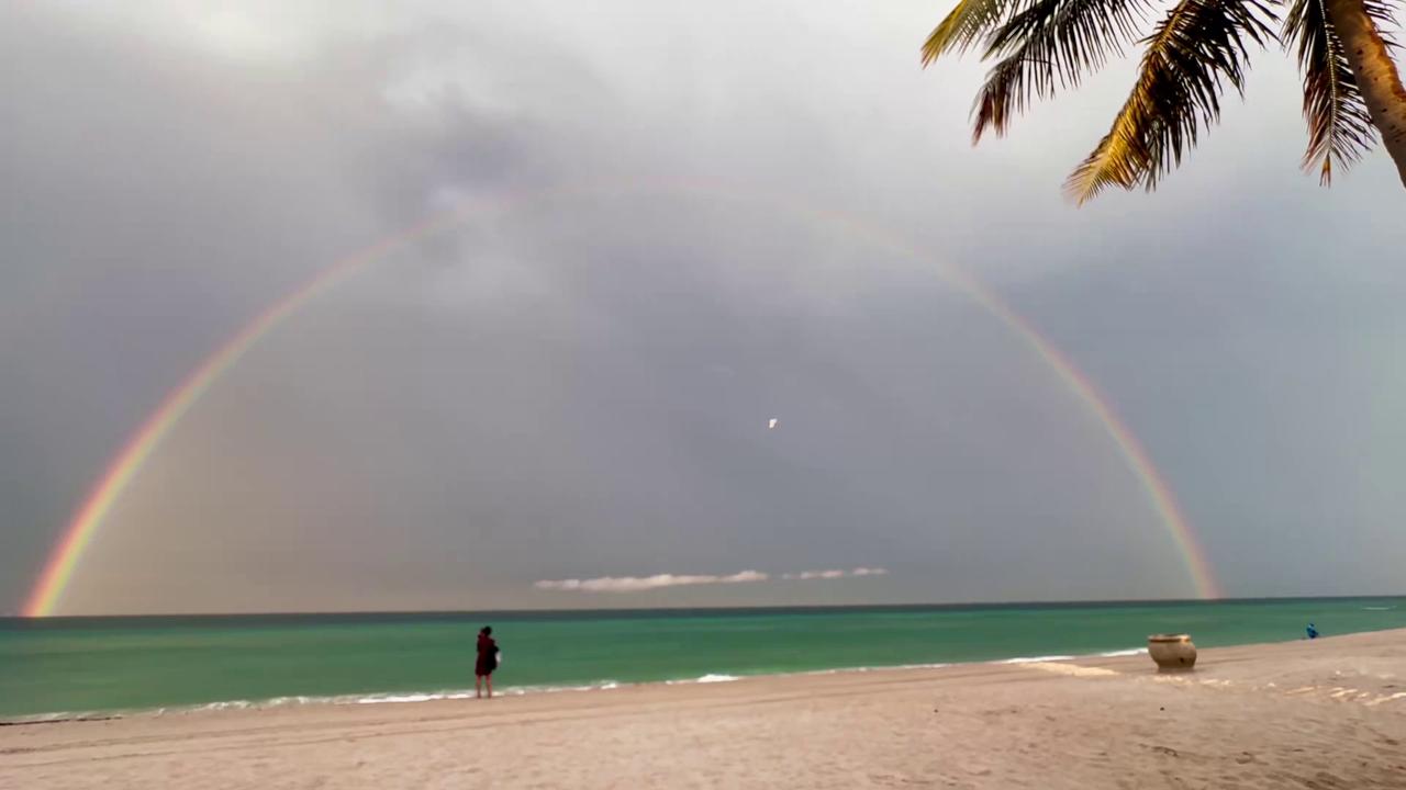Video thumbnail for US: Rainbow Appears Over Hollywood Beach After Thunderstorms.