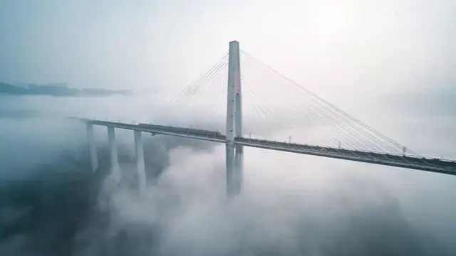 Video thumbnail for China: Otherworldly fog turns Chongqing bridge into dreamscape as metro train passes.