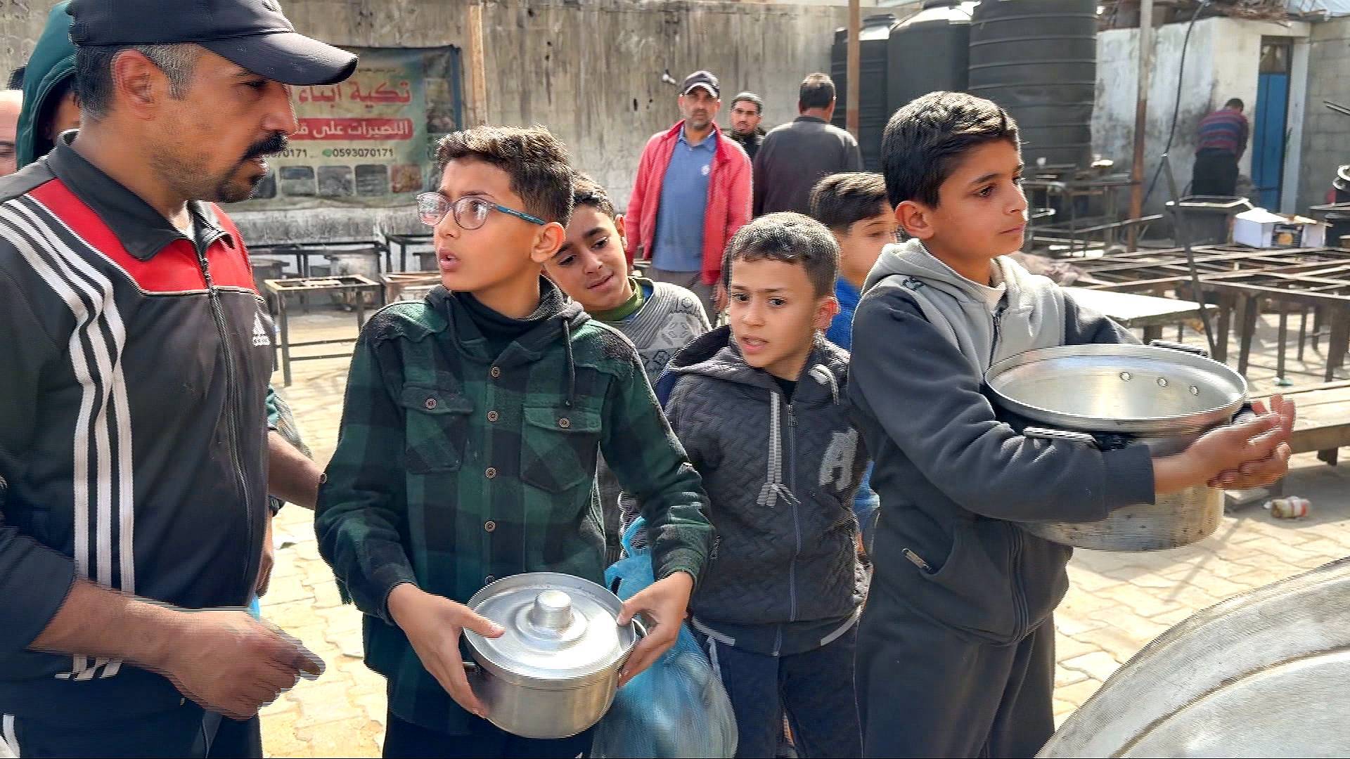 Video thumbnail for Gaza children queue at community kitchens for their families' only daily meal