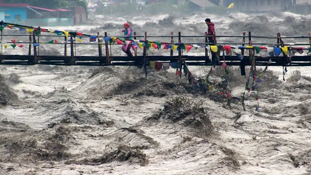'Video thumbnail for Building collapses into overflowing river during India floods'