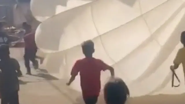'Video thumbnail for Children in Gaza play games with aid drop parachute'
