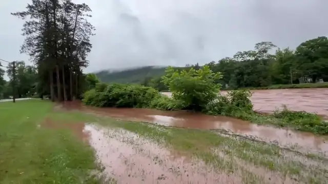 Video thumbnail for US: Floodwaters Swallow Road Near New York As Creek Bursts Its Banks.