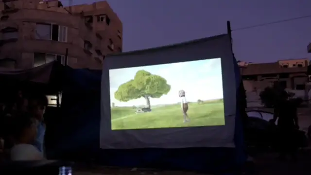 'Video thumbnail for Makeshift cinema camp gives children temporary escape from war in Gaza'