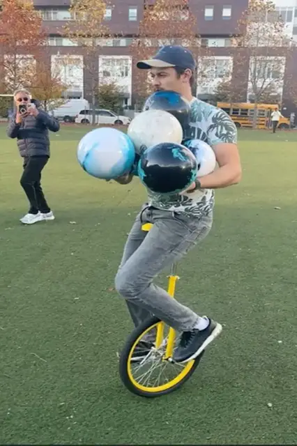 'Video thumbnail for Most bowling balls held simultaneously while riding a unicycle - 6 by Ishtar Chandaria'
