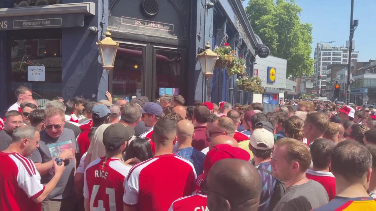 Video thumbnail for UK: Arsenal fans outside the Twelve Pins in Finsbury Park in London.
