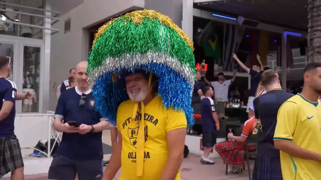Video thumbnail for US: Brazil and Scotland fans gather on Miami's Ocean Drive ahead of World Cup match.