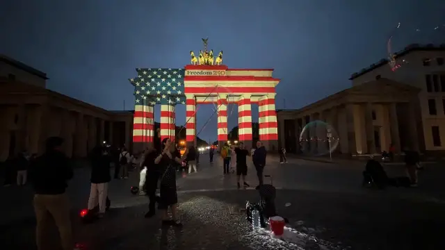 Video thumbnail for Germany: US flag colors light up Brandenburg Gate for 250th anniversary.