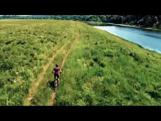 Video thumbnail for An aerial view at a man riding a bicycle
