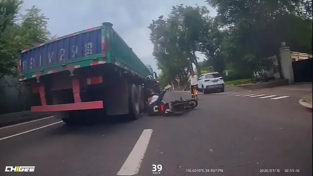 Video thumbnail for China: Chinese riders nearly crushed after dangerous overtaking beside large truck.