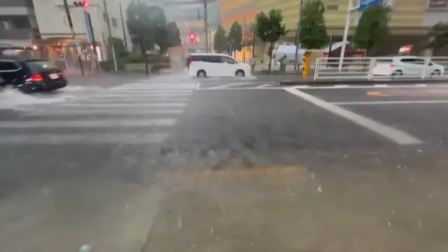 Video thumbnail for Japan: Cars Plough Through Deep Floodwater as Torrential Rain Hits Tokyo.