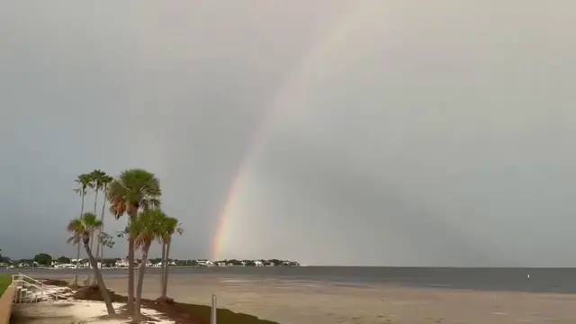 Video thumbnail for US: Tampa Bay Sky Erupts In Color As Rainbow And Massive Cloud Bank Rise Over The Water.